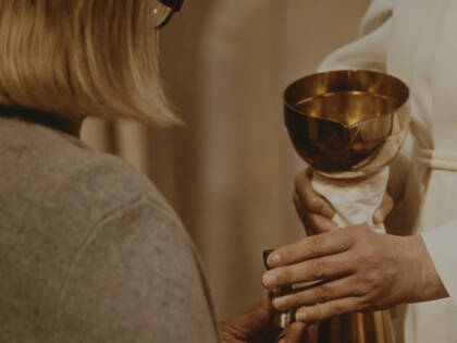 A woman is receiving communion.