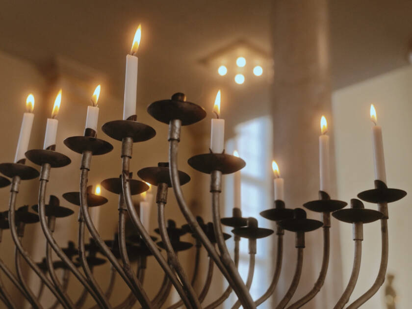 A chandelier with lighted candles.