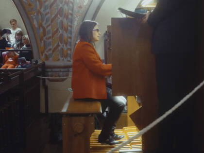 An organist playing the organ in church.