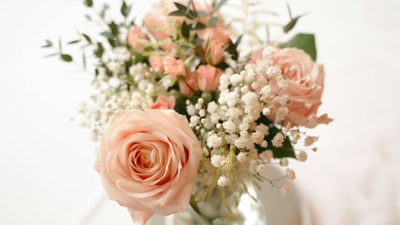 A wedding bouquet with pink and white flowers.