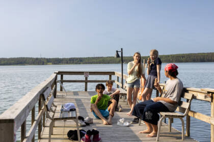 Young people eating ice cream on the pier.