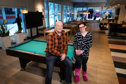Two people at the pool table at the Kismus youth café.