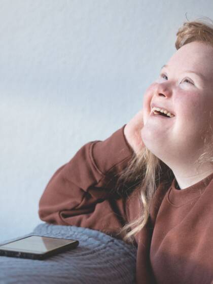 A happy girl looks up with a smile.